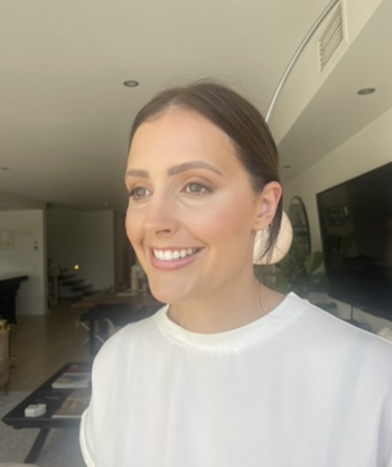 Soft bronze glam with a sleek low bun